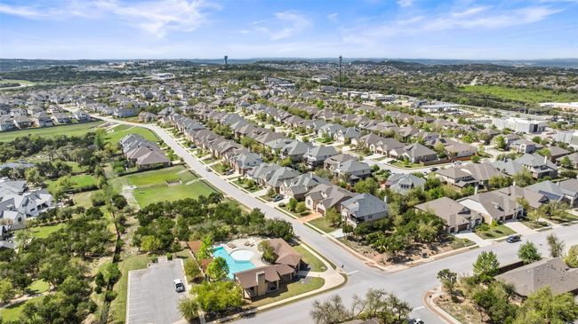 Community pool, Summer Moon, and retail shops just a short stroll away and ?? gorgeous Hill Country views right in your own neighborhood! | Image 35