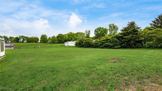 View of yard featuring a view of rural / pastoral area, an outbuilding, and view of scattered trees | Image 17