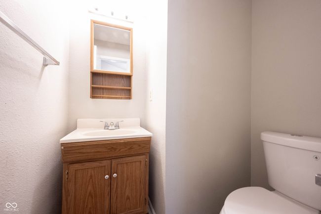 half bathroom featuring toilet and vanity | Image 5