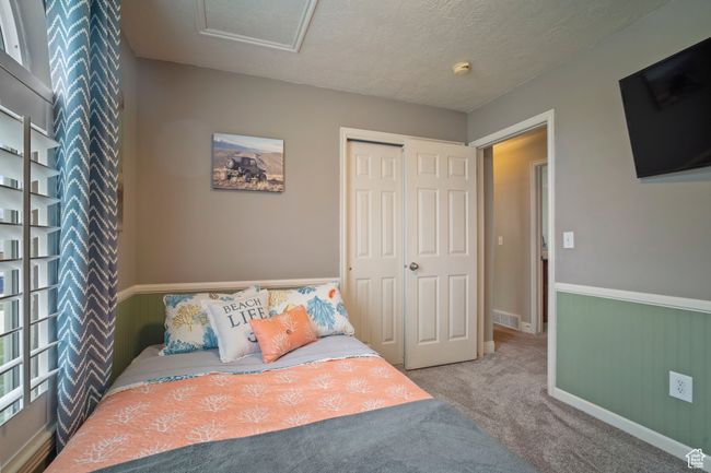 Carpeted bedroom with baseboards, visible vents, attic access, and a closet | Image 15