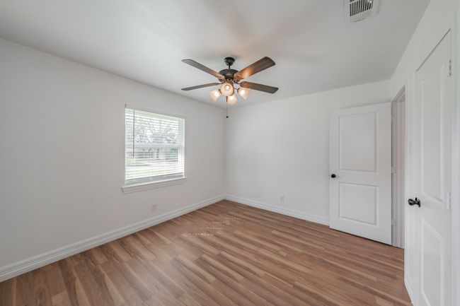 Empty room featuring light wood finished floors, ceiling fan, and baseboards | Image 26
