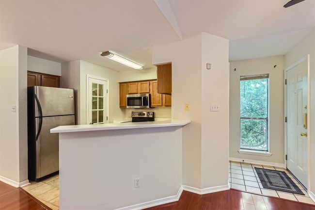 Kitchen and entryway with side window. | Image 8