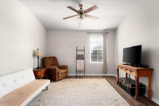 Sitting room featuring ceiling fan, wood finished floors, and baseboards | Image 19