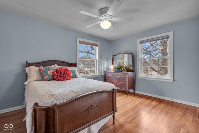 bedroom featuring baseboards, ceiling fan, and wood finished floors | Image 23