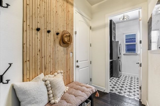 Mudroom with stacked washer / dryer, baseboards, and dark floors | Image 13