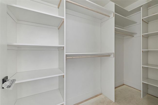 Spacious closet with light wood-style floors | Image 36
