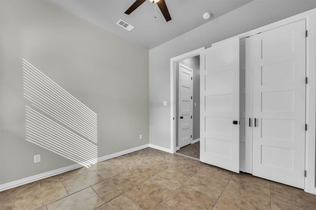 Unfurnished bedroom featuring ceiling fan and light tile patterned floors | Image 24