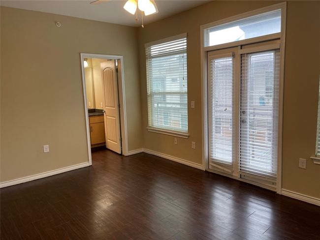 Empty room featuring a ceiling fan and dark wood-type flooring | Image 20