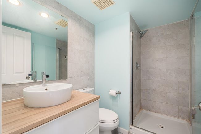 Bathroom with vanity, a shower stall, and tile walls | Image 17