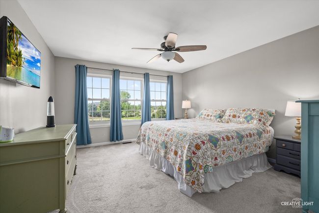 The spacious primary has a ceiling fan with light | Image 14