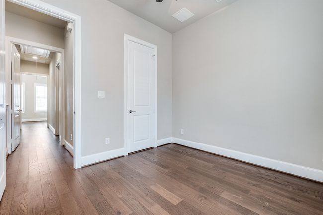 Unfurnished bedroom featuring attic access and wood finished floors | Image 23