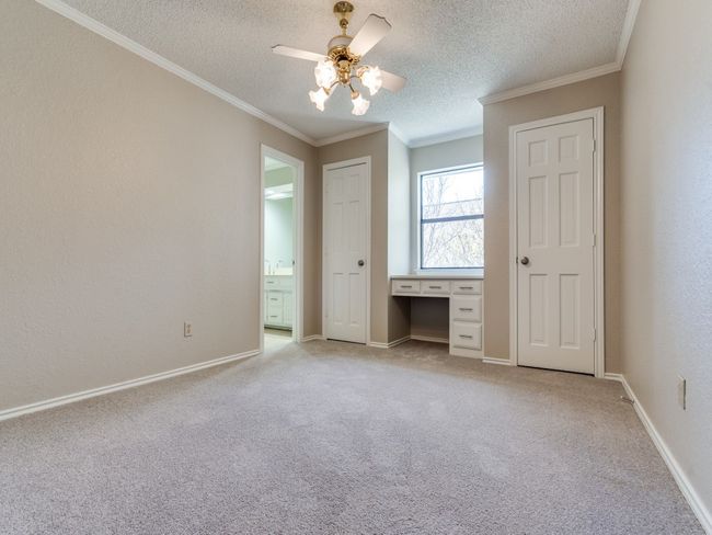 Bedroom 4 upstairs has built in desk and two closets, and shares a full bath with bedroom 3. | Image 28
