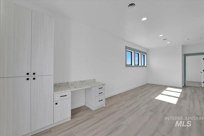 Unfurnished office featuring light wood-type flooring, recessed lighting, and built in study area | Image 22