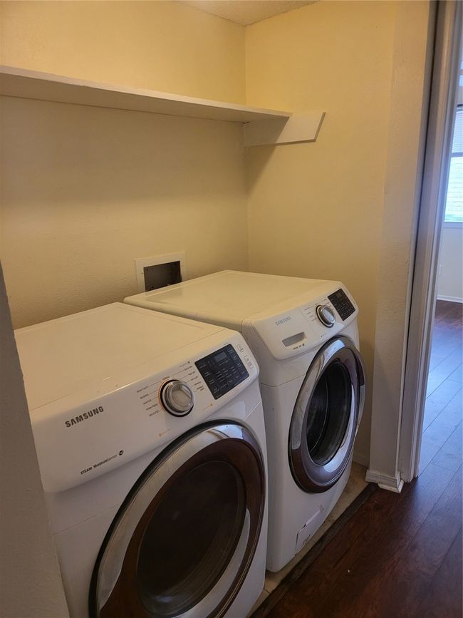 Laundry area featuring dark wood-type flooring, laundry area, baseboards, and separate washer and dryer | Image 17