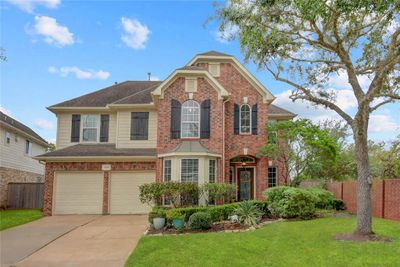 A STUNNING TWO-STORY BRICK HOME NESTLED AT THE END OF A QUIET CUL-DE-SAC, FEATURING A METICULOUSLY LANDSCAPED FRONT YARD THAT EXUDES CHARM AND OFFERS EXCEPTIONAL CURB APPEAL. | Image 1