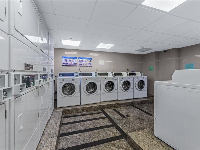 Shared laundry room featuring estacked washer and dryer and separate washer and dryer | Image 13