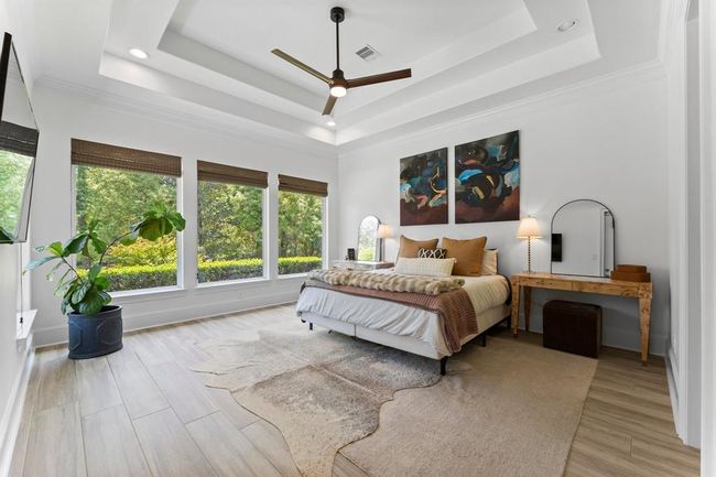 The primary suite itself features high ceilings and beautiful large windows that let in plenty of natural light and create an atmosphere that’s light, bright, and airy. | Image 16
