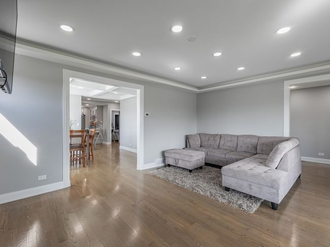 Sun-drenched living room with gleaming hardwood fl | Image 14