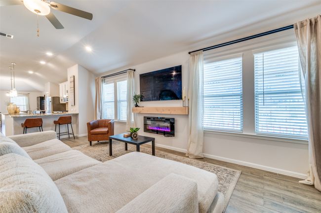 Living room featuring baseboards, vaulted ceiling, recessed lighting, light wood-style flooring, and a ceiling fan | Image 4