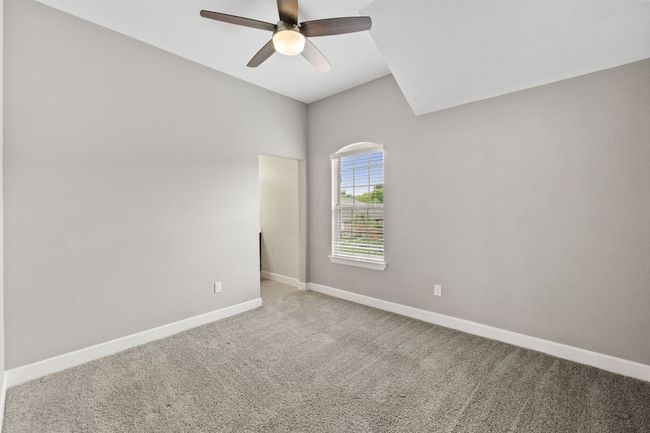 Empty room with ceiling fan, carpet floors, and baseboards | Image 31