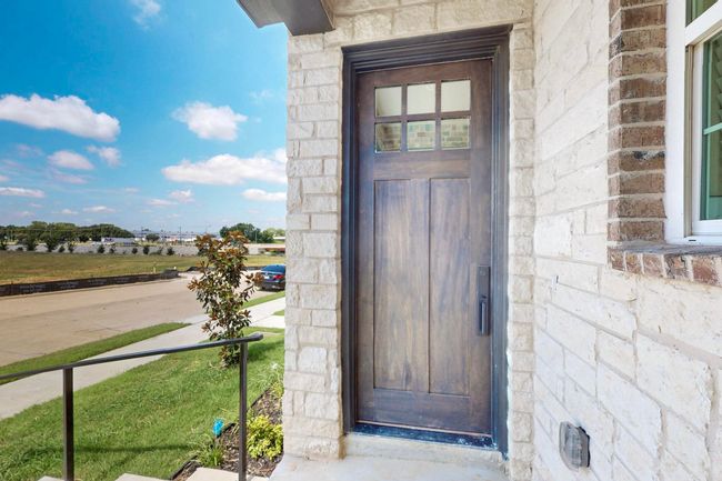 Doorway to property featuring stone siding | Image 4