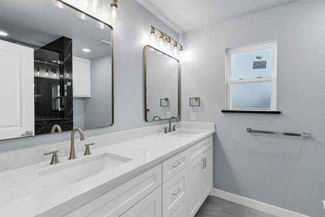 Full bathroom with baseboards and double vanity | Image 29