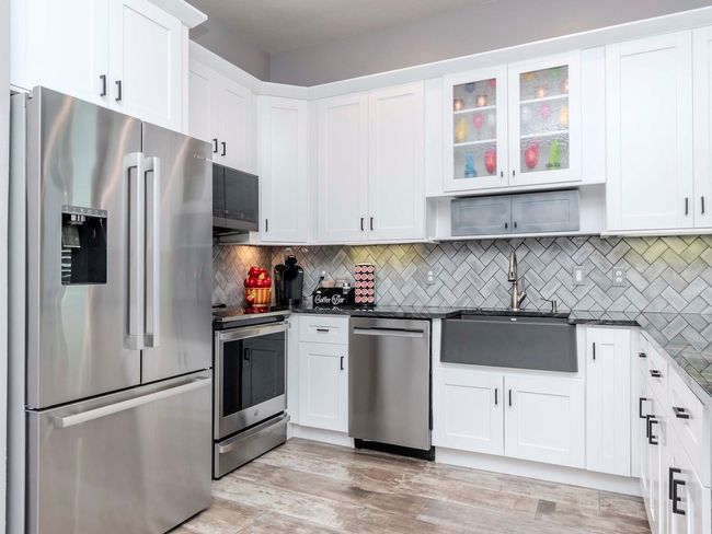 GOURMET KITCHEN W/ GRANITE WATERFALL COUNTERTOPS | Image 6