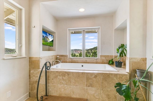 Full bath with healthy amount of natural light and a garden tub | Image 25