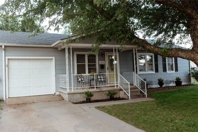 Charming Ranch-style house featuring a garage, a front yard, and covered porch, Large Mature Trees | Image 2