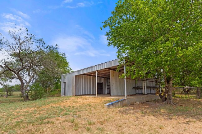 View of yard featuring an outbuilding and an outdoor structure | Image 37