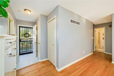 Hall with light hardwood / wood-style flooring | Image 3