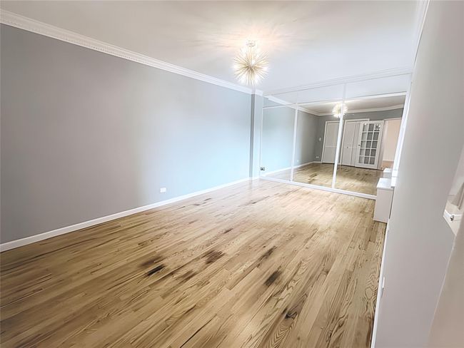 Spare room with crown molding and light wood finished floors | Image 7