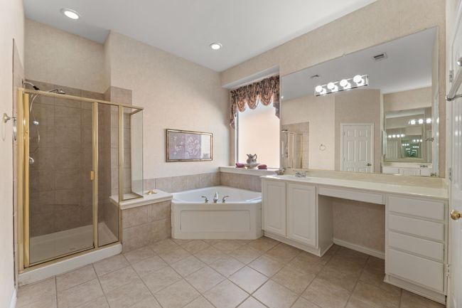 Bathroom with vanity, shower with separate bathtub, and tile patterned floors | Image 30