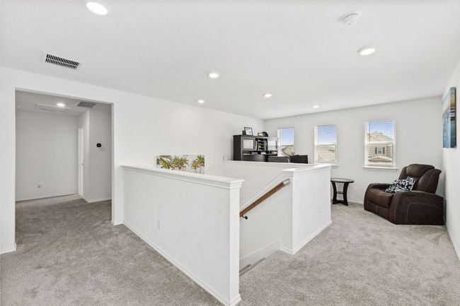 Hallway featuring an upstairs landing, light colored carpet, and recessed lighting | Image 21