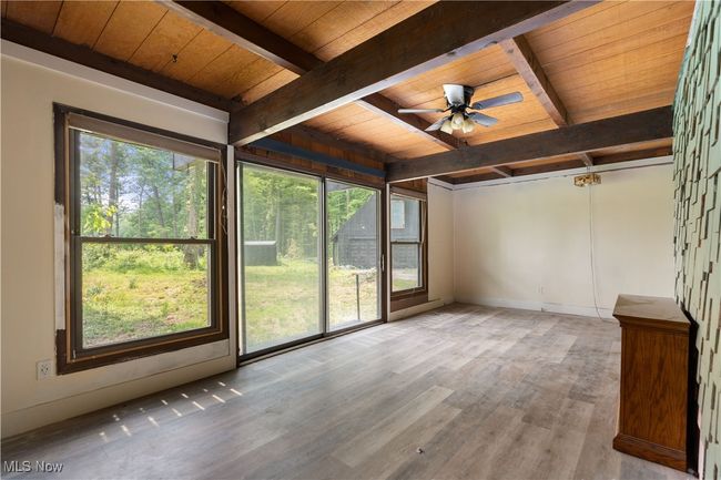 Unfurnished sunroom with beam ceiling | Image 25