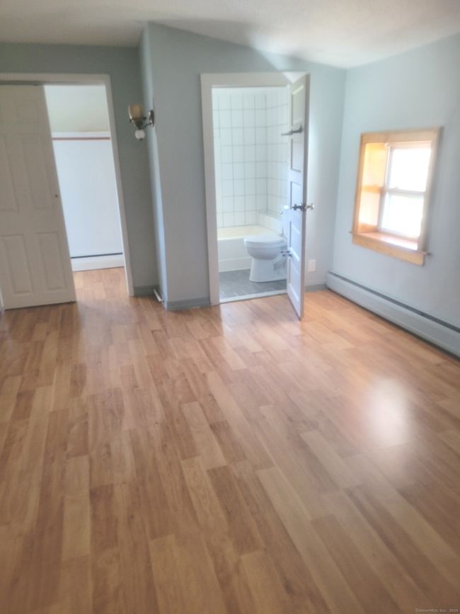 The primary bedroom features its own full bath and walkin closet | Image 6