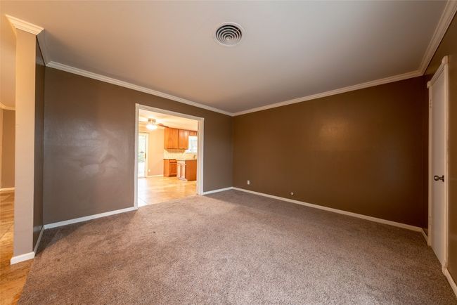Spare room with ornamental molding and light colored carpet | Image 18
