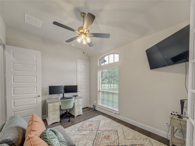 Office area with dark wood-style floors, a ceiling fan, and lofted ceiling | Image 8