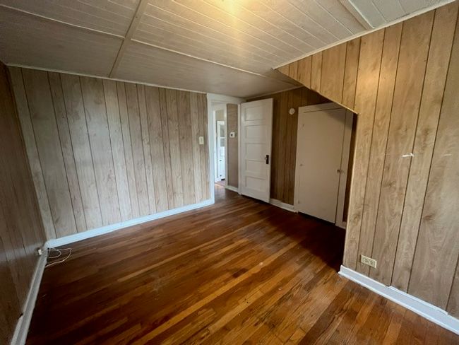 Unfurnished room with wood walls, wood-type flooring, and wood ceiling | Image 30