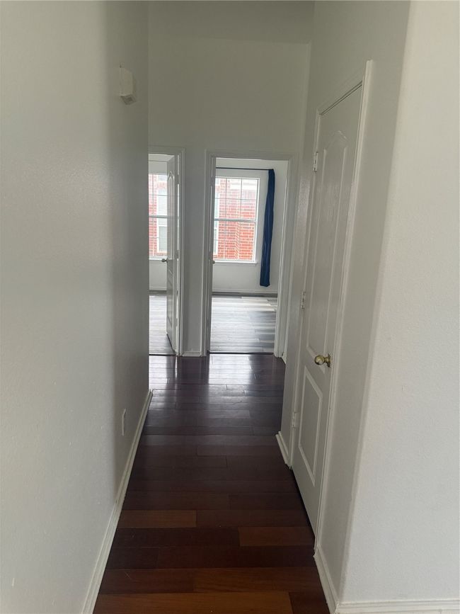 Hall with dark wood finished floors and baseboards | Image 15