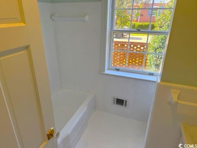 Bathroom with a tub to relax in and tile walls | Image 32