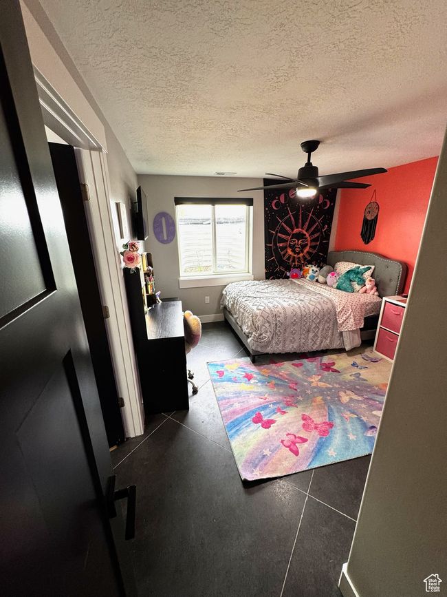 Bedroom featuring a textured ceiling and a ceiling fan | Image 19