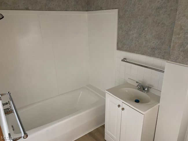 Bathroom with vanity and hardwood / wood-style floors | Image 10