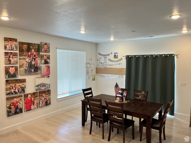 Dining room featuring light wood-style flooring, baseboards, and recessed lighting | Image 8