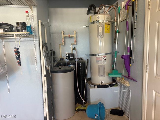 Utility room featuring strapped water heater | Image 70