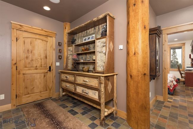 Entry level door to garage and hallway to Bedroom 1 Suite. | Image 46
