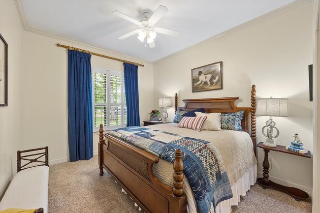 Bedroom with crown molding, carpet, and ceiling fan | Image 22