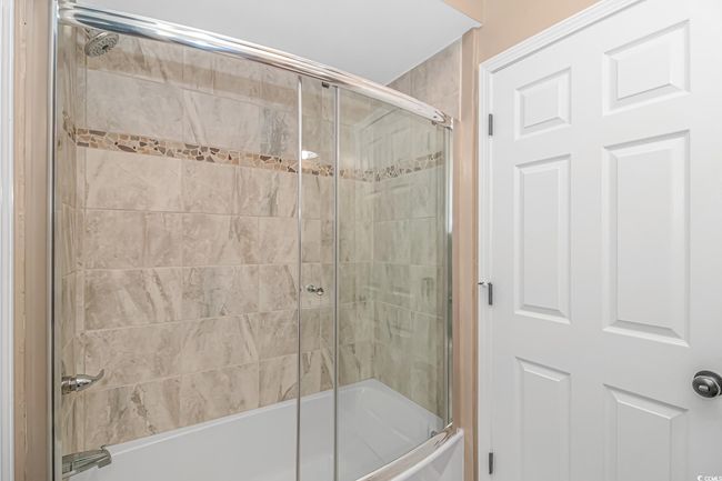 Bathroom featuring enclosed tub / shower combo | Image 21