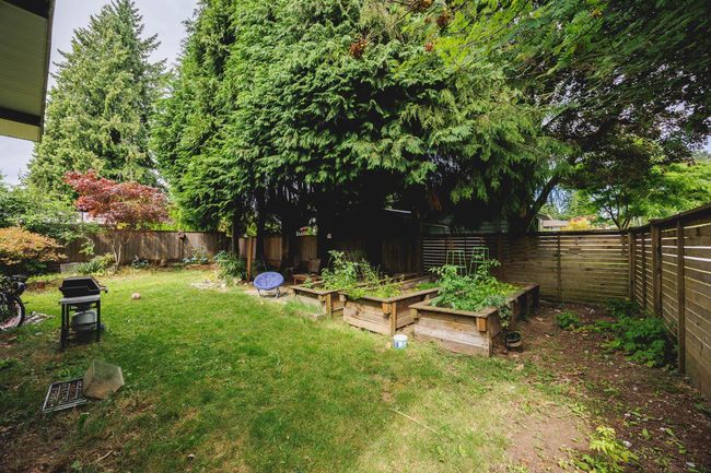Fenced backyard featuring a garden | Image 36