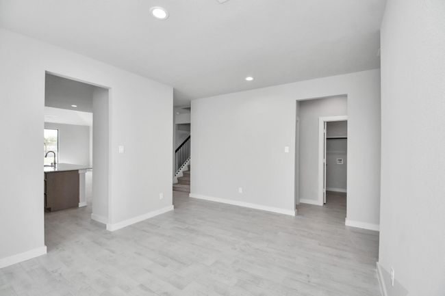 Craft enduring memories with loved ones around the table! This roomy dining area boasts stylish flooring, personalized paint, and is conveniently situated next to the family room and kitchen, fostering an open and inclusive ambiance. | Image 11